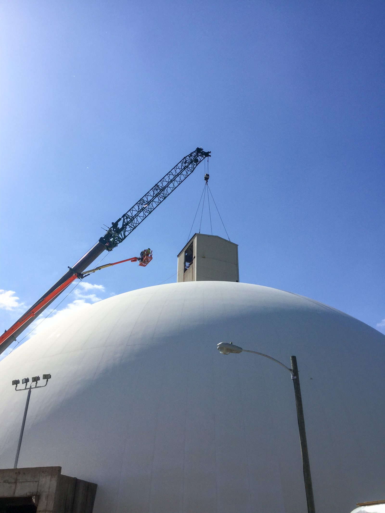 Crane lifting the conveyor headhouse from the top of the Cargill salt storage dome