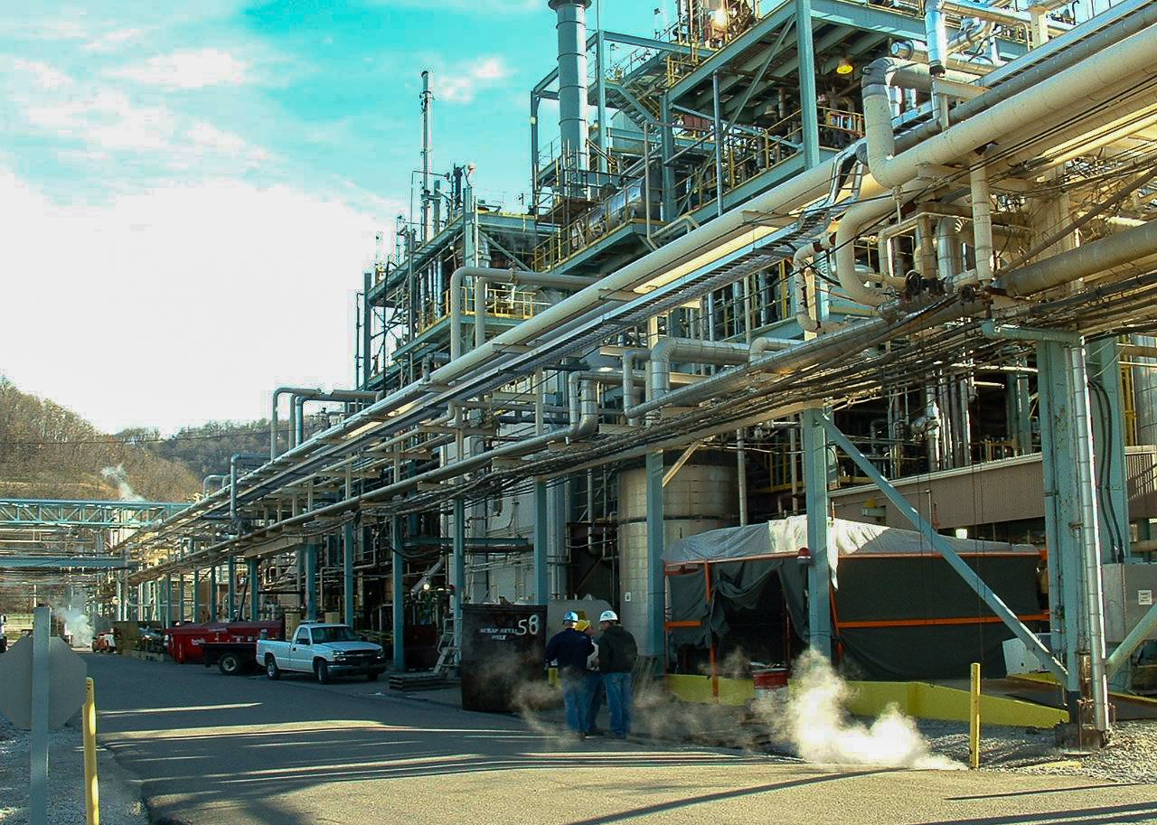Process piping and utility racks along a roadway through a pharmaceutical manufacturing campus