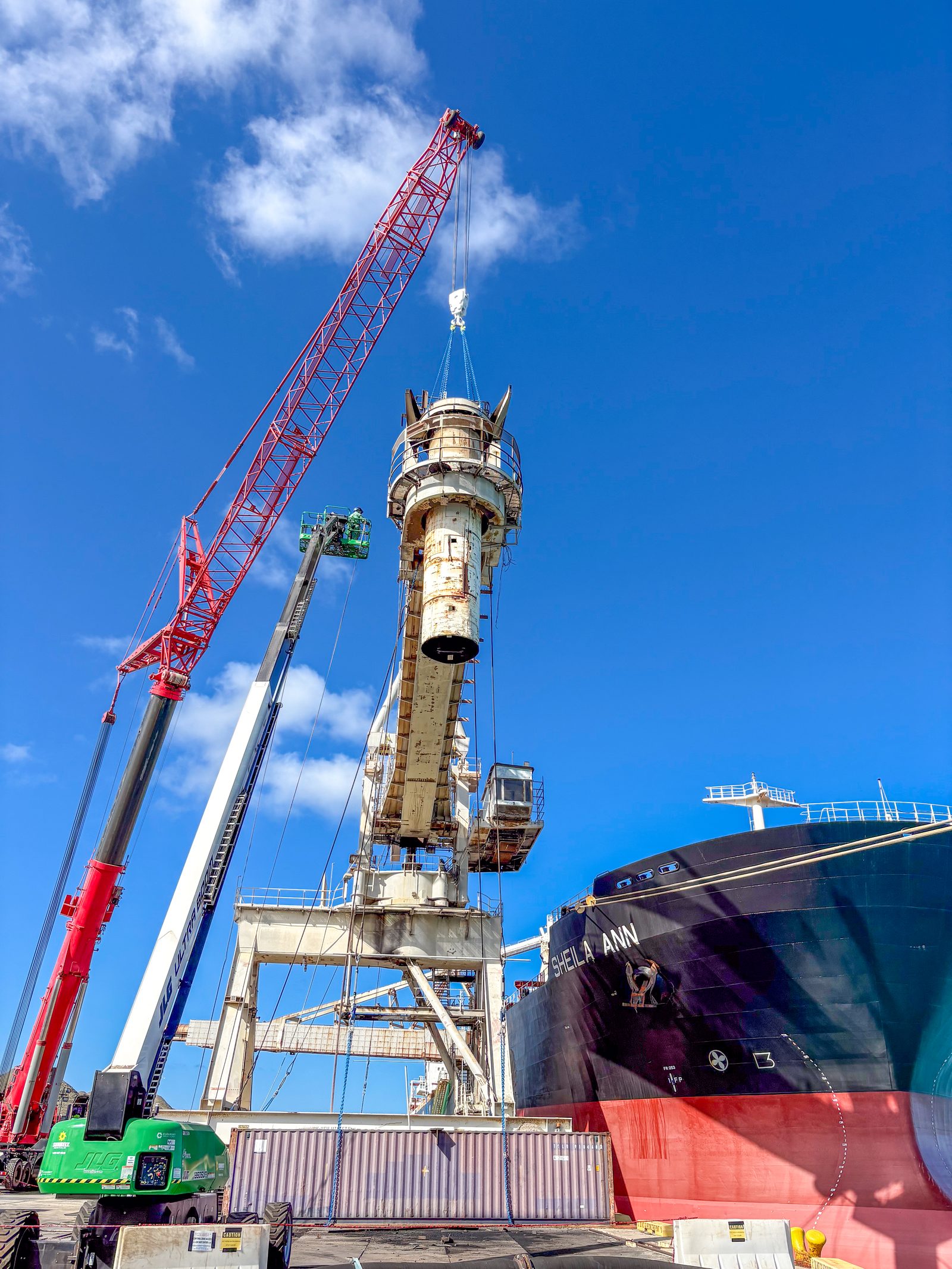 Crane lifting a dismantled section of the continuous ship unloader at the AES Hawaii harbor facility