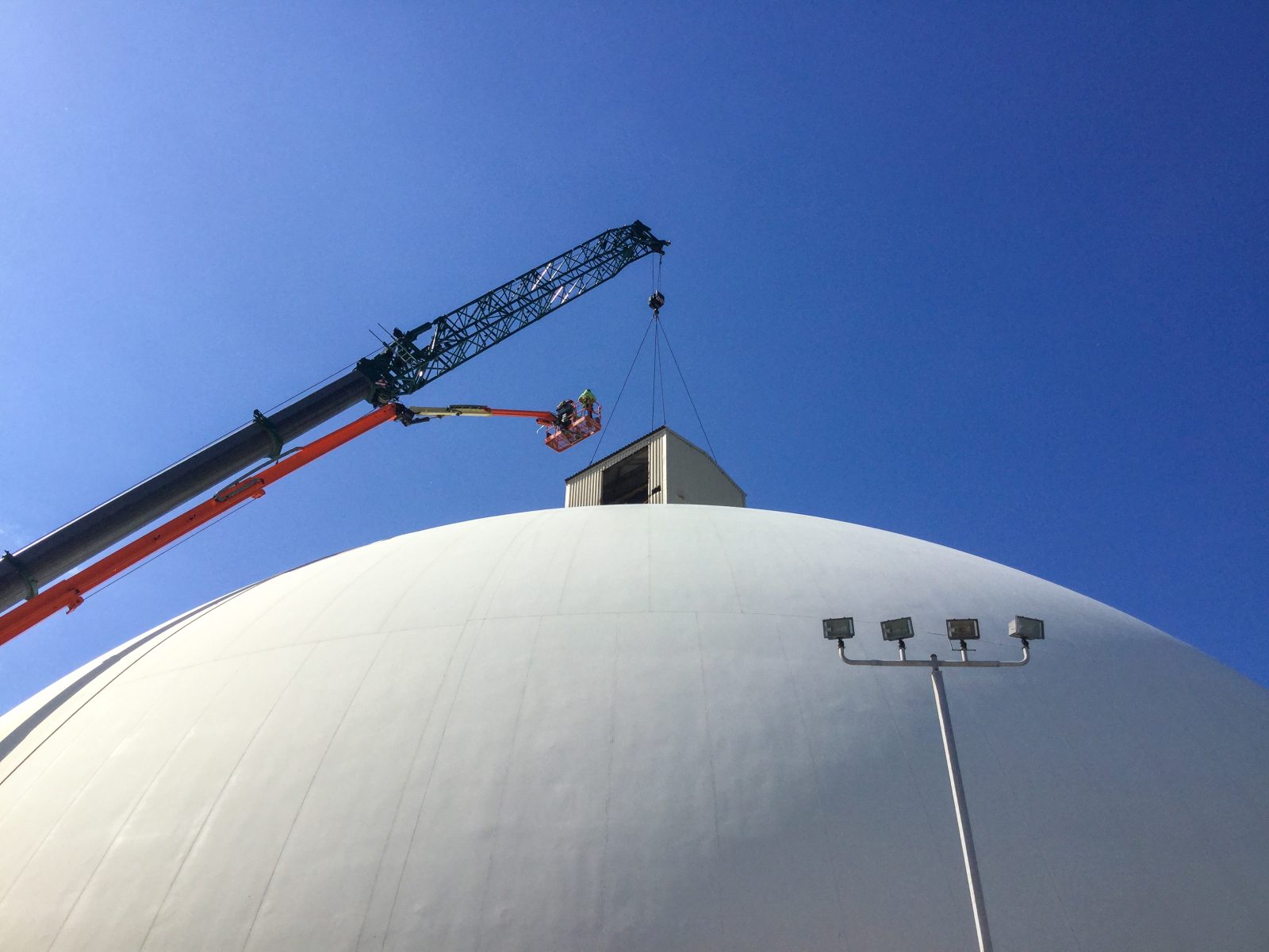 Crane and manlift crew working above the igloo-style salt storage dome at Cargill's Hersey plant